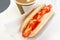 Simple hot dog sandwich with mustard ketchup and coffee