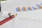 Simple Illustration Photo 1 Sitting Mini Figure old man Toy Reading Graphic Business Chart at Red Wood Pencil