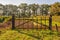 Simple iron gate between two wooden beams