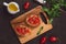 Simple italian appetizing bruschetta with tomato, on wooden tabl