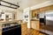 Simple kitchen interior with wooden cabinets and steel refrigerator