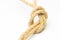 Simple knot on yellow background with esparto rope