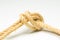 Simple knot on yellow background with esparto rope