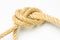 Simple knot on yellow background with esparto rope