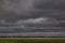 Simple landscape with stripes of field, clouds and trees