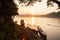 Simple life, golden light shines down around the Mekong River, small wooden boat returning home in the evening, vegetable garden