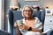 Simple living. Senior woman sitting alone on chair at home drinking tea or coffee enjoying her time and life. Older female
