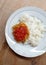 A simple menu, rice with flour fried chicken and sambal or tomato chili sauce. Selective focus.