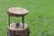 Simple and minimalist do it yourself homemade bird feeder made of tree trunk and branches with fat ball in the middle fixed with