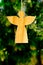 Simple natural wooden Angel with sunlit greenery background