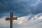 Simple oak catholic cross, storm clouds in the background