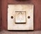 Simple old doorbell, rectangle door bell switch with a bell symbol on it, object macro, extreme closeup, front view, frontal shot