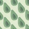 Simple pale seamless patern with avocados silhouettes. Green colored fruits on light grey background
