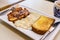 Simple pork chop, fried eggs, bread breakfast in Hong Kong