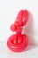 Simple red twisted balloon animal rabbit on white. Toy of balloons, bunny. Balloon art.