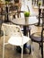 Simple retro style coffee shop interior with white and black chairs