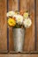 Simple, rustic country style fall autumn Thanksgiving season floral dahlia bouquet in galvanized metal vase home decorations