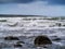 Simple seascape, powerful waves and cloudy sky, nobody