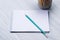 Simple sharp pencil lies on a blank writing pad