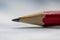 A simple sharpened slate pencil lies on the table on a white background, close-up, selective focus. Concept: start with