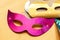 Simple small colorful cardboard paper party masks on the table, object closeup. children birthday party accessories, masquerade