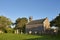 The simple small Victorian Parish Church of Dun with its Gothic features lit up in the Golden light of the evening Sun.