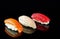 Simple sushi nigiri maki set isolated on black background. Various selection of traditional japanese food