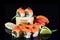 Simple sushi nigiri maki set isolated on black background. Various selection of traditional japanese food