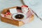 Simple Valentine& x27;s day breakfast in bed for Lover. A cup of coffee and bagel with jam, heart-shaped gift box with red