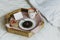 Simple Valentine`s day breakfast in bed for Lover. A cup of coffee and bagel with jam, heart-shaped gift box with red ribbon,