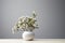 Simple, white backdrop highlights the charm of small potted flowers