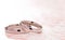 Simple White Gold Wedding Rings on a Pink Table