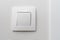 Simple white light switch, turn on or turn off the lights hanging on the white wall in the room