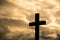 Simple wood catholic cross silhouette, dramatic orange storm clouds in the background,