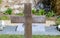 Simple wooden cross on a grave in a cemetery