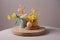 simple wooden round podium with a vase and fresh blooms on springtime