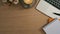 Simple workplace with laptop, coffee cup, notebook and flower pot. Top view.