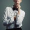 Simplicity is the ultimate sophistication. Studio shot of a young woman wearing a shirt and bow tie against a gray