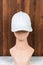 The simplicity of a white blank hat brings understated elegance to a fashion head doll in this captivating mockup image