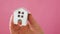 Simply design female woman hand holding miniature white toy house isolated on pink pastel colorful trendy background