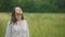 Simply dressed woman feeling oneness with nature standing in wheat field, hands