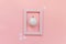 Simply minimal composition winter objects ornament ball in pink frame isolated on pink pastel trendy background