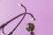 Simply minimal design with medicine equipment stethoscope or phonendoscope isolated on trendy pastel purple violet background.