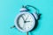 Simply minimal design ringing twin bell vintage classic alarm clock Isolated on blue pastel background. Rest hours time of life