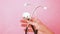 Simply minimal design woman hand holding medicine equipment stethoscope or phonendoscope isolated on trendy pastel pink