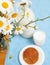 Simply stylish wooden kitchen with bottle of milk and glass on table, summer flowers camomile, healthy food morning