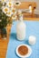 Simply stylish wooden kitchen with bottle of milk and glass on table, summer flowers camomile, healthy foog moring