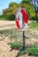 Simrishamn, Sweden - 13 May 2019: Lifebuoy on an empty sandy beach on a sunny day