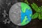 Simulation world on the ground and trees Half of the world is bright, green trees, the other half indicates the horror of