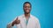 Sincere approval concept. Young black medical doctor gesturing thumb up and smiling to camera